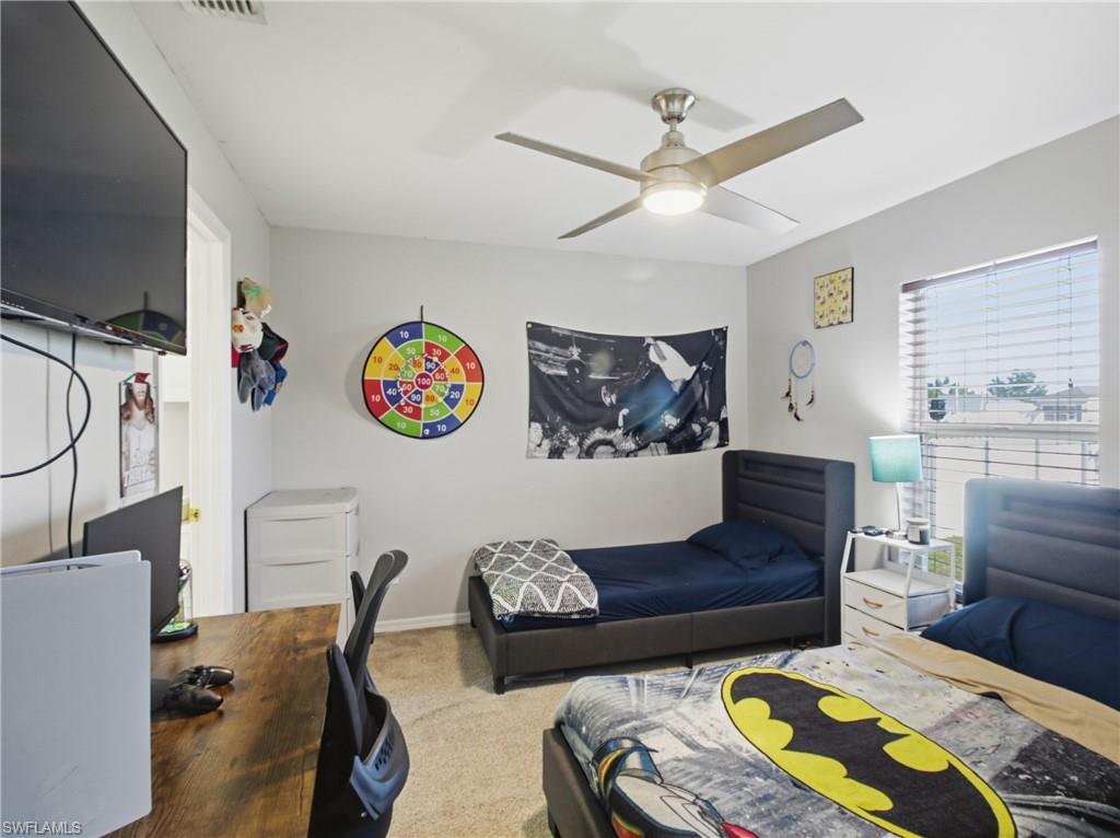 Bedroom 2 with a desk, carpet, and ceiling fan