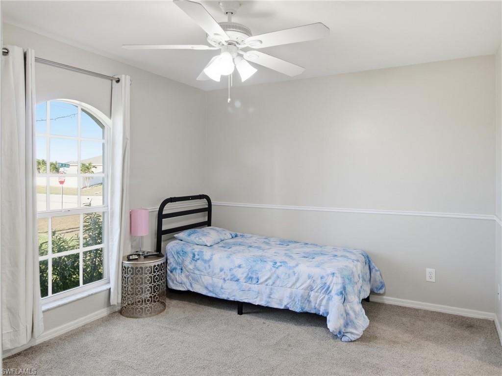 Bedroom 1 featuring carpet and ceiling fan