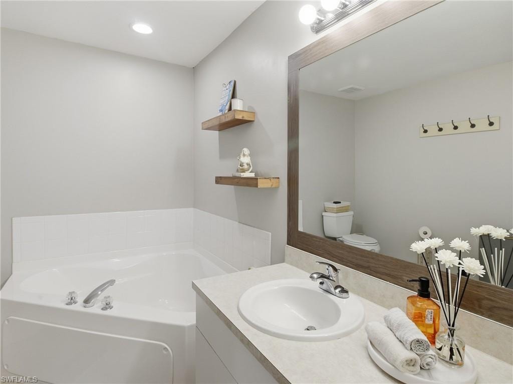 Master Bathroom with a tub and vanity