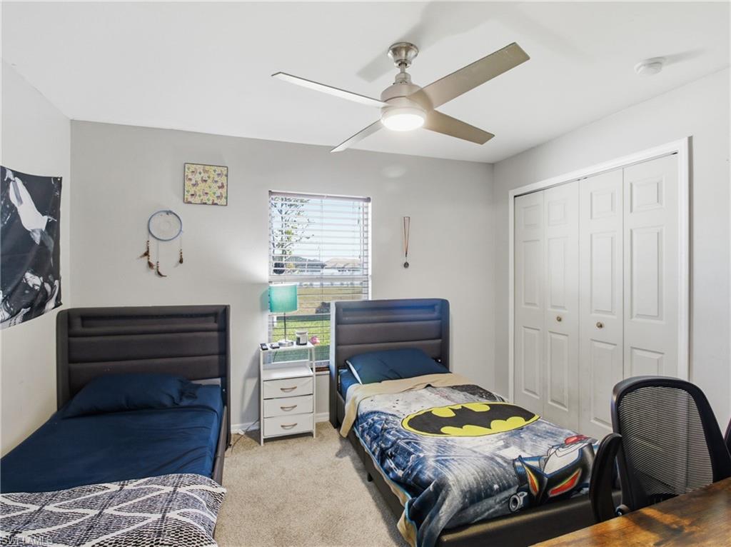 Bedroom 2 with carpet, a closet, and ceiling fan