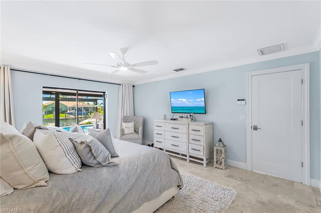 Primary bedroom featuring access to lanai and crown molding