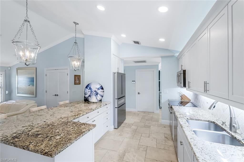 Bright & open kitchen with Bosch appliances and level 3 granite countertops. Bosch package includes an induction stove and a refrigerator with a 15 bottle wine drawer.