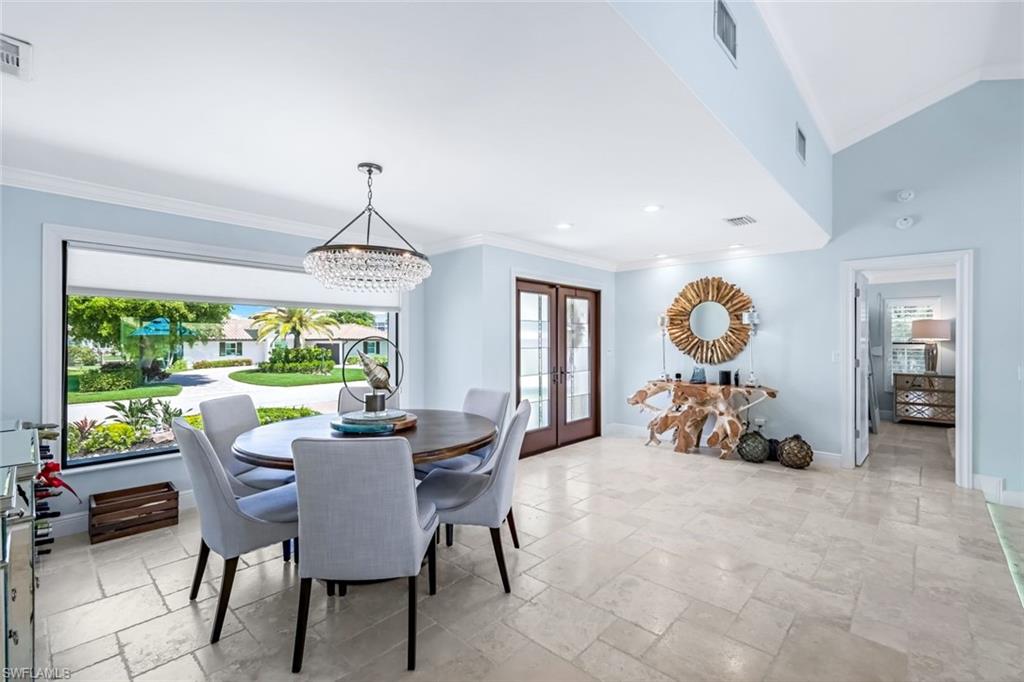 Formal dining room with large picture window open to formal living room