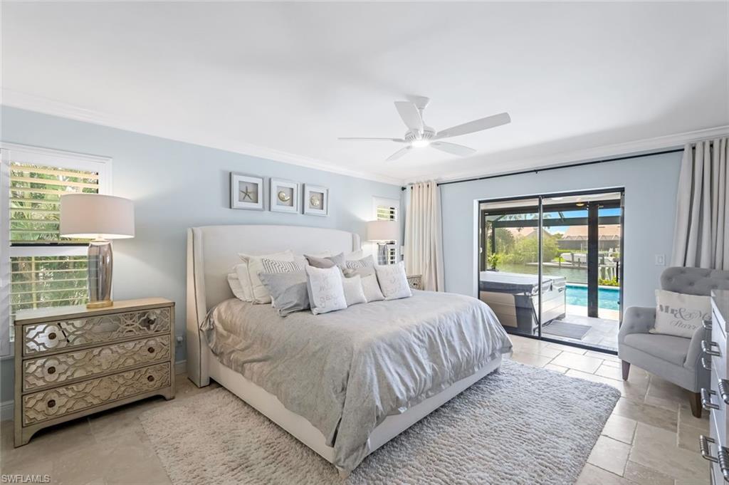 Primary bedroom featuring access to lanai and crown molding