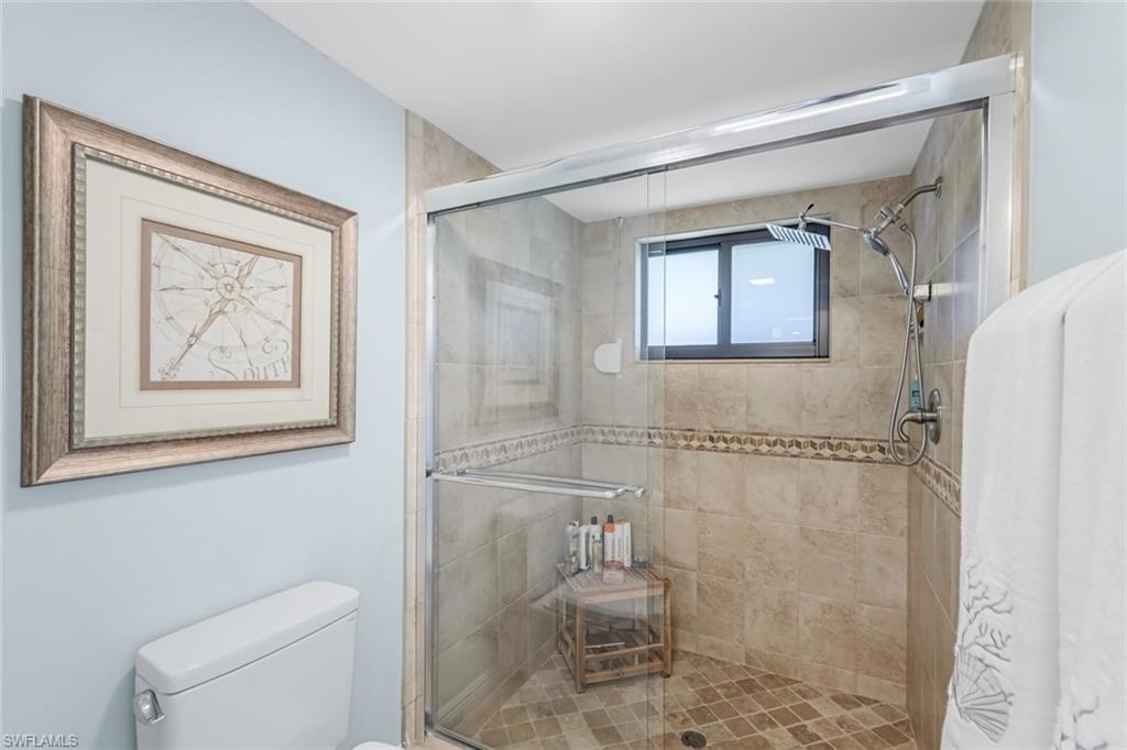 Primary bathroom with spa-inspired finishes with a walk in shower.