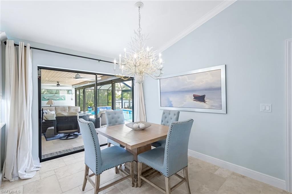 Breakfast space featuring crown molding, vaulted ceiling, and beautiful outdoor view.