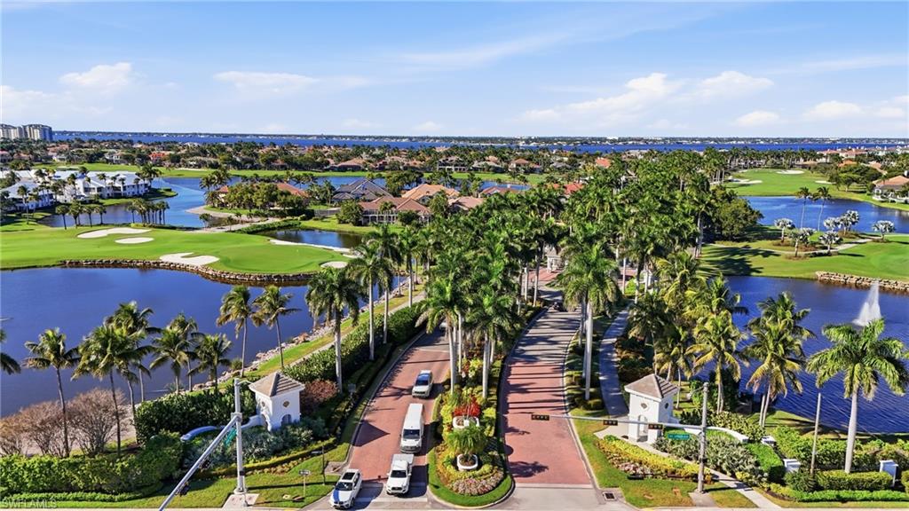 Aerial view of residential area with a golf club and a large body of water