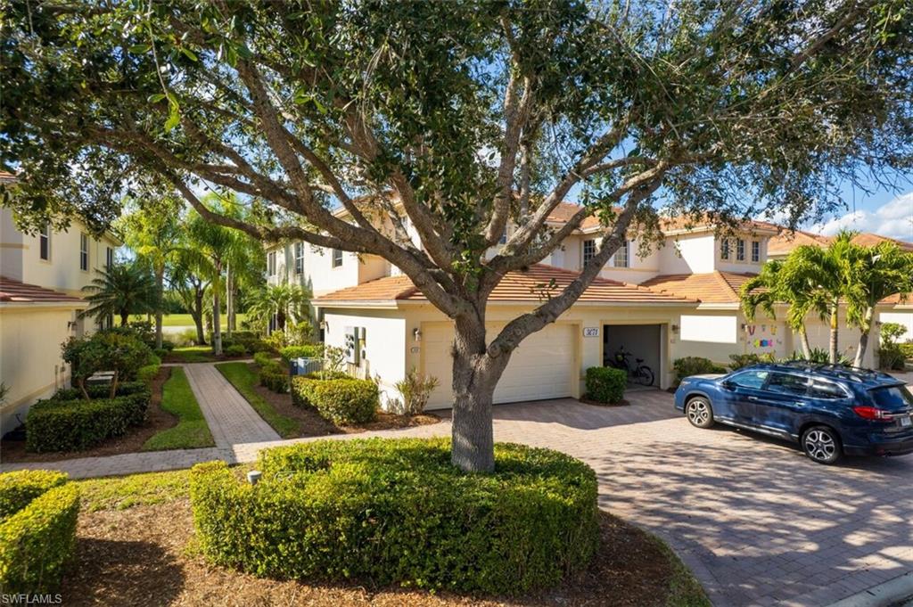 Mediterranean / spanish-style home with decorative driveway, a garage, a tile roof, and stucco siding