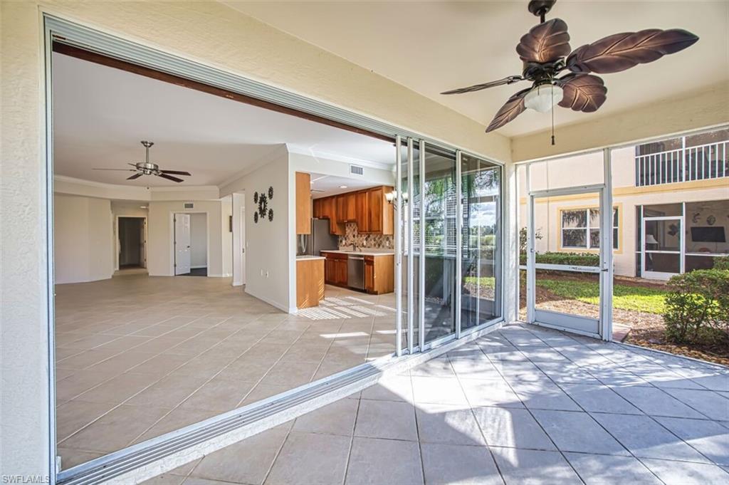 Unfurnished sunroom with ceiling fan
