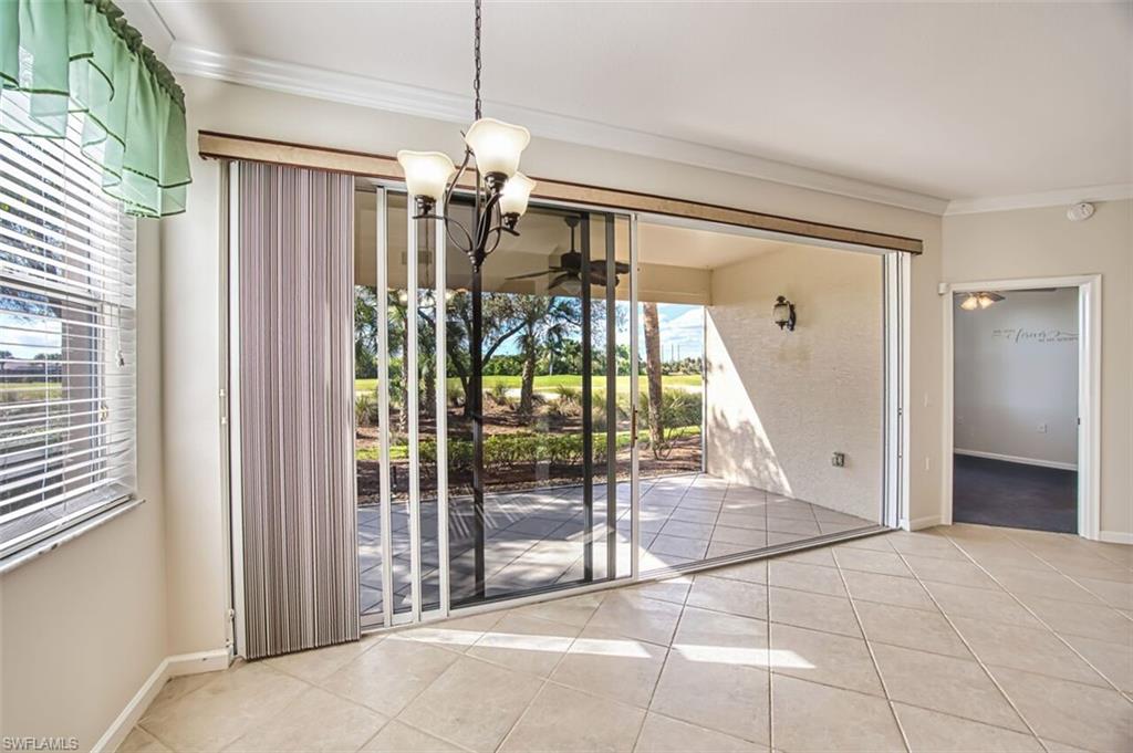 Unfurnished dining area with crown molding, a chandelier, and light tile patterned floors