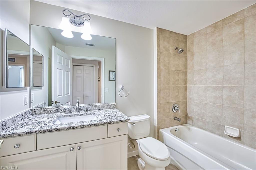 Full bathroom featuring washtub / shower combination and vanity