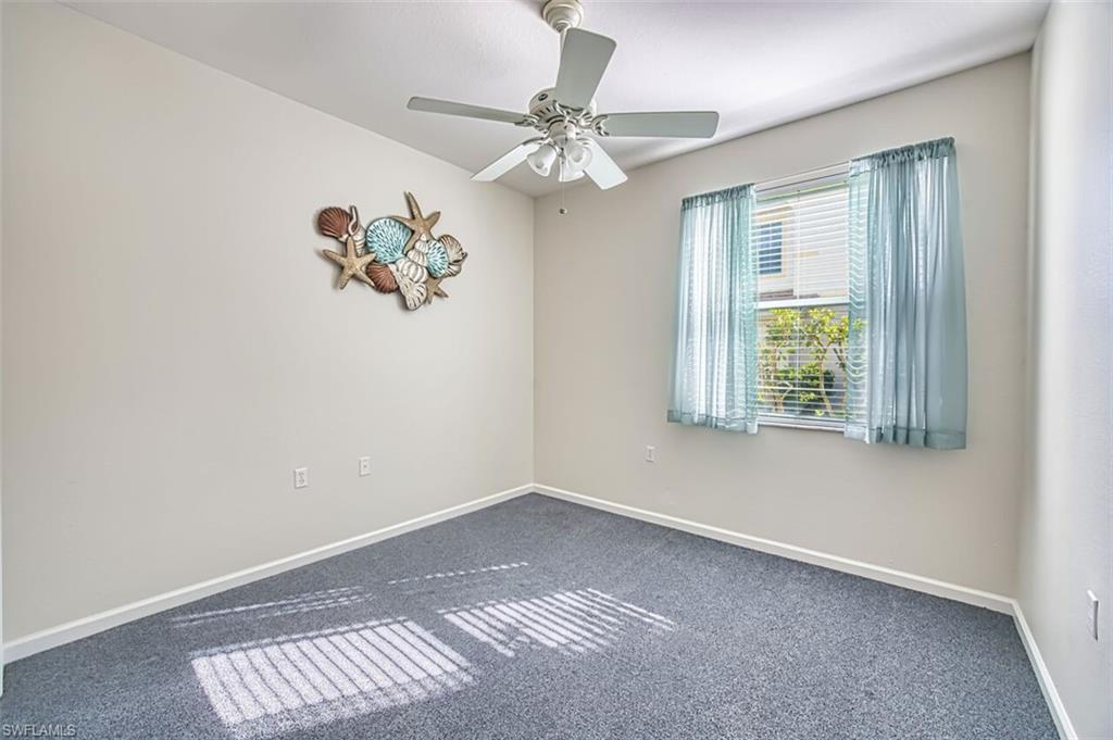 Empty room featuring carpet and a ceiling fan