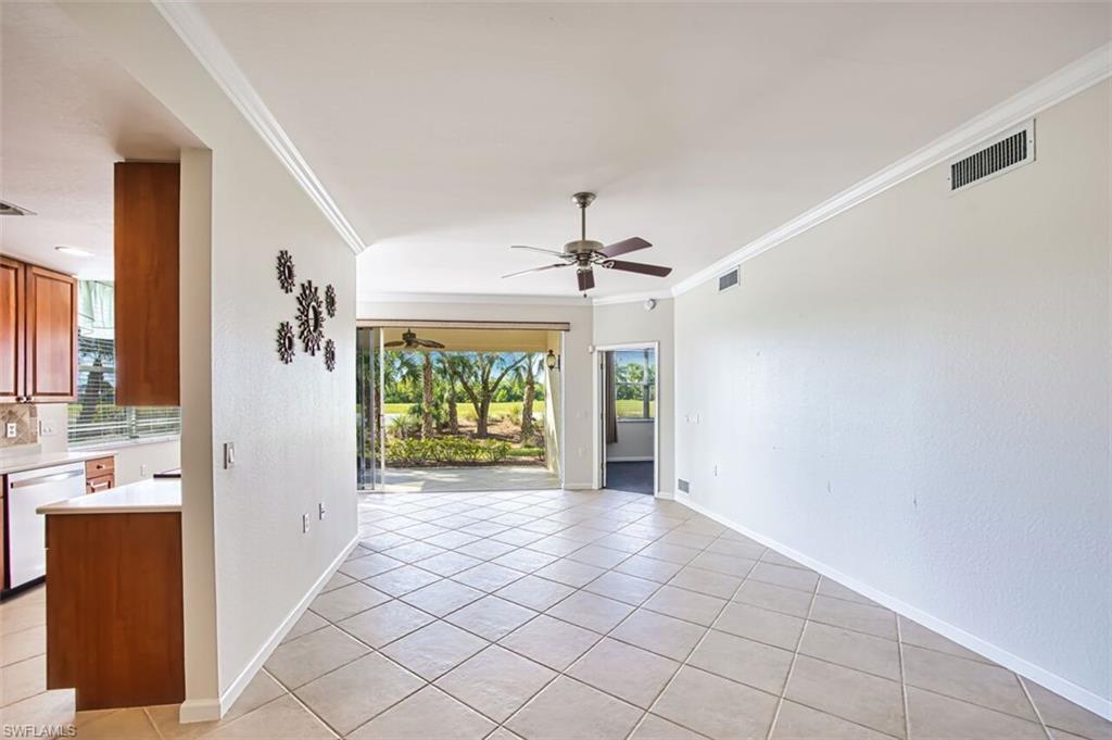Spare room with ornamental molding, light tile patterned floors, and ceiling fan