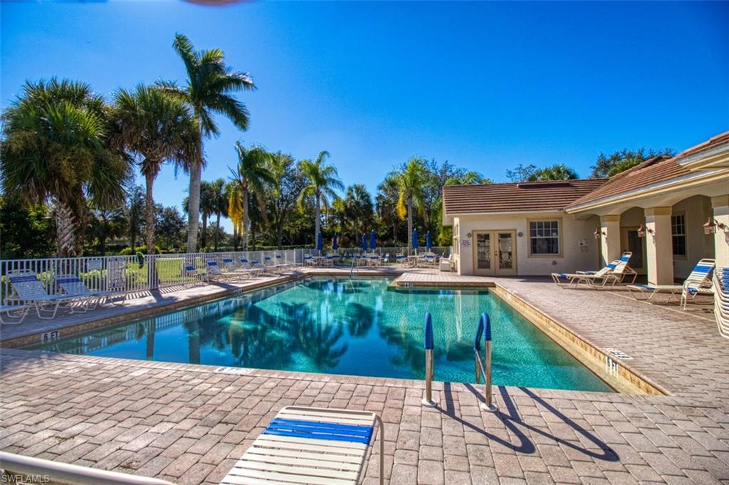 Community pool with a patio and french doors