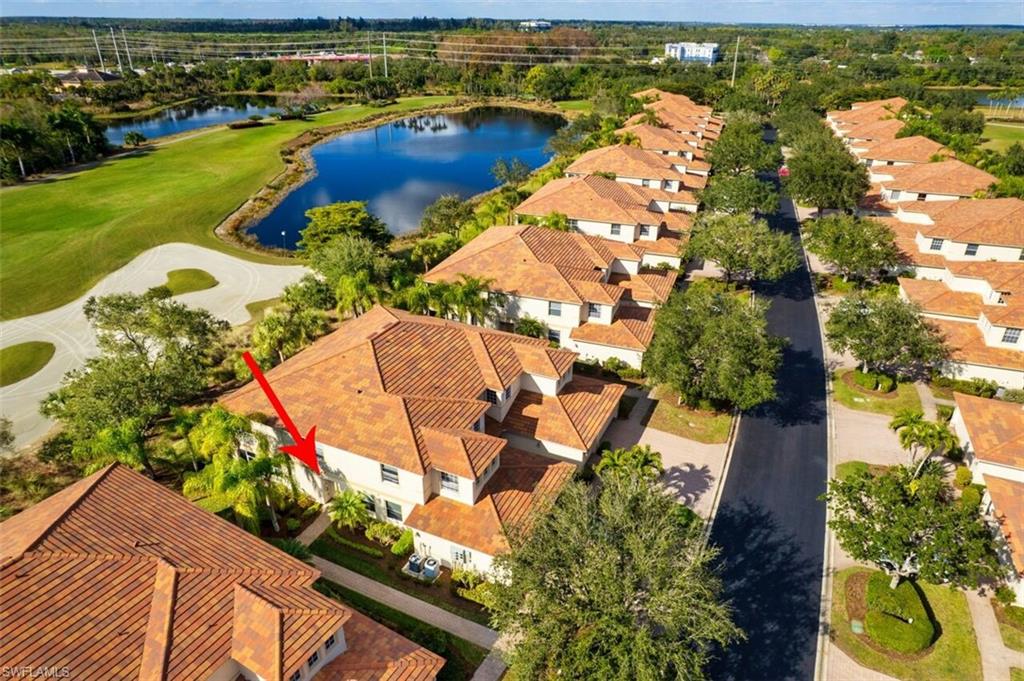 Aerial perspective of suburban area with a large body of water and a golf club