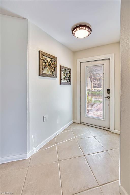 Entryway featuring baseboards and tile patterned floors