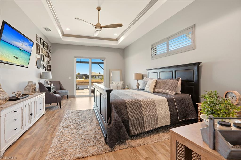 Primary Bedroom featuring light wood-type flooring, access to outside, ceiling fan, and recessed lighting