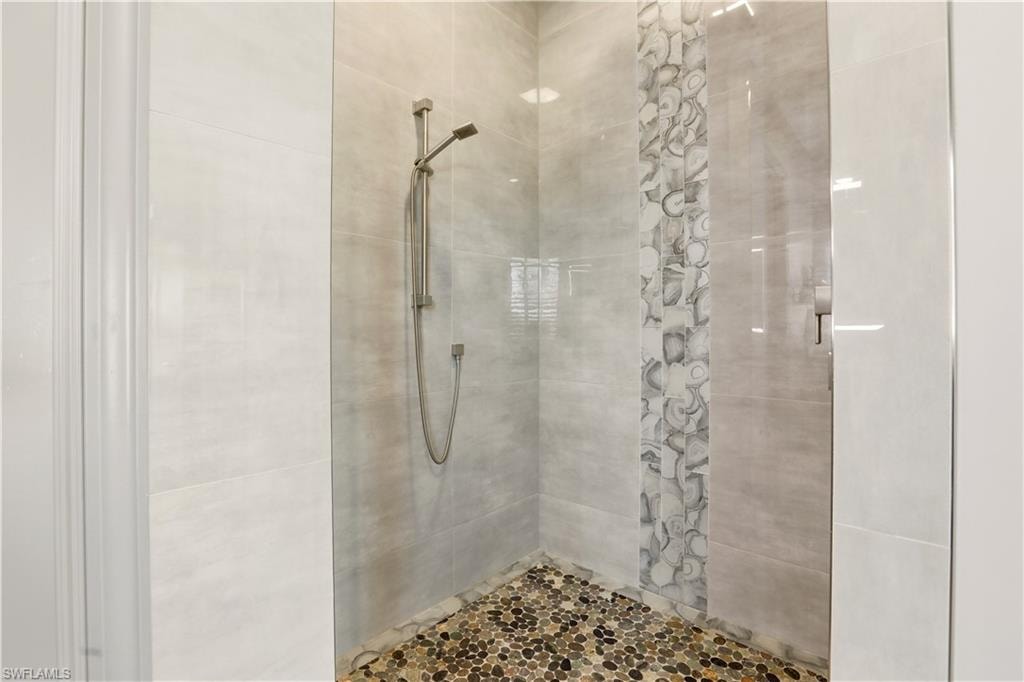 Primary Full bathroom featuring a tile shower with custom listello.