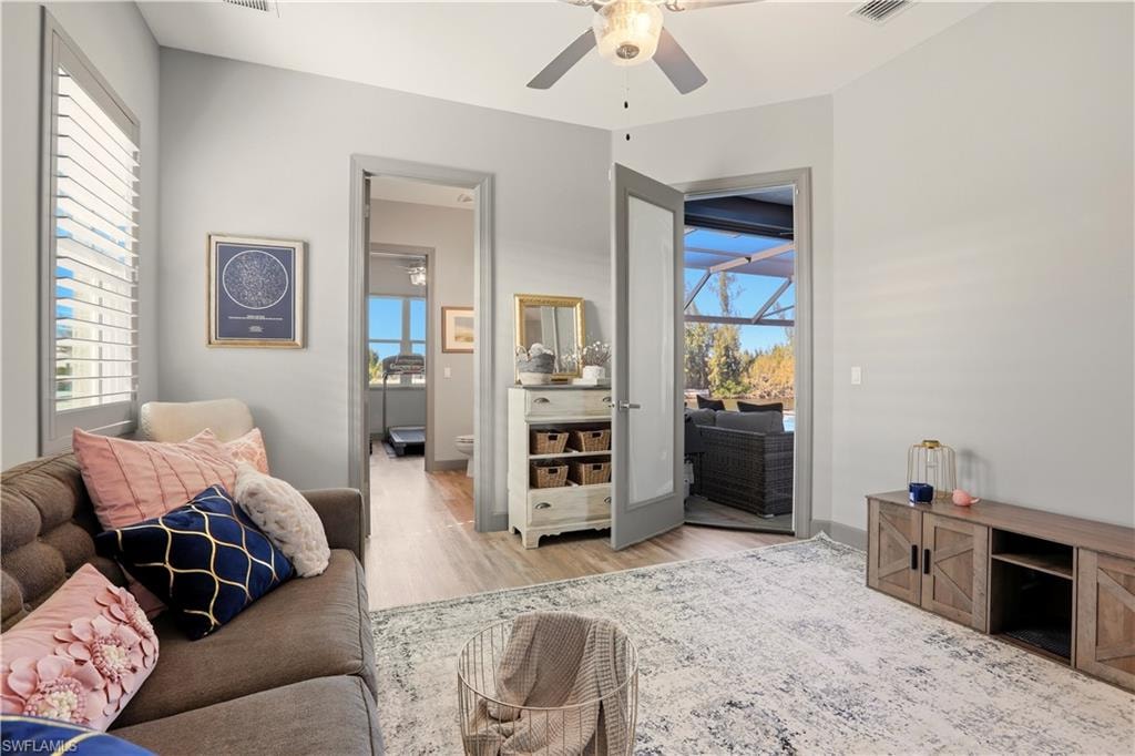 4th Bedroom featuring ceiling fan, light wood finished floors, and a an entry to the Covered Lanai.
