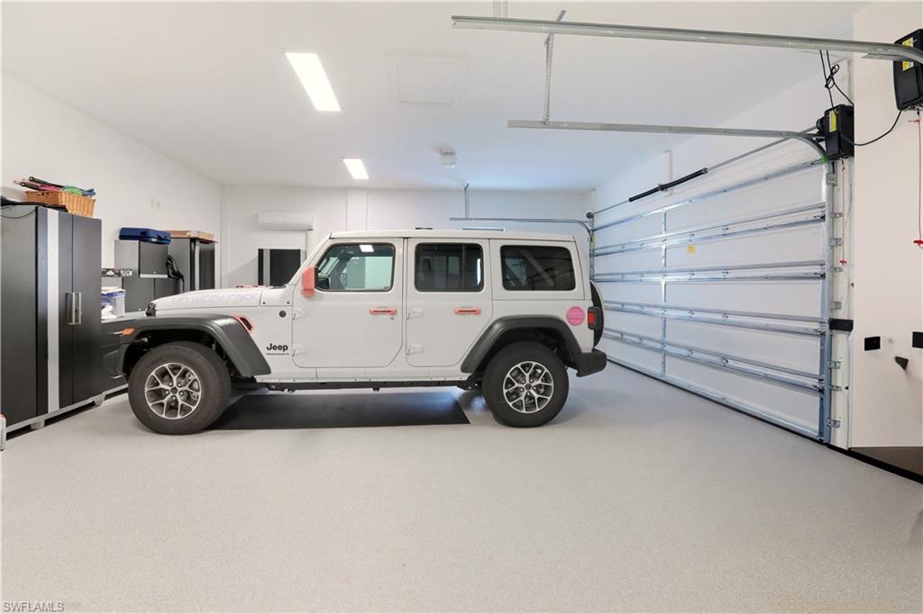 For those who appreciate the finer things in life, the garage is a true gem. With epoxy flake floors featuring filled cuts and baseboards, a mini-split air conditioner, and an upgraded Wayne Dalton 9100 insulated garage door, it's an ideal space for everything from vintage car storage to DIY projects.
