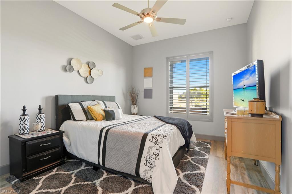 2nd Bedroom with light wood finished floors and ceiling fan