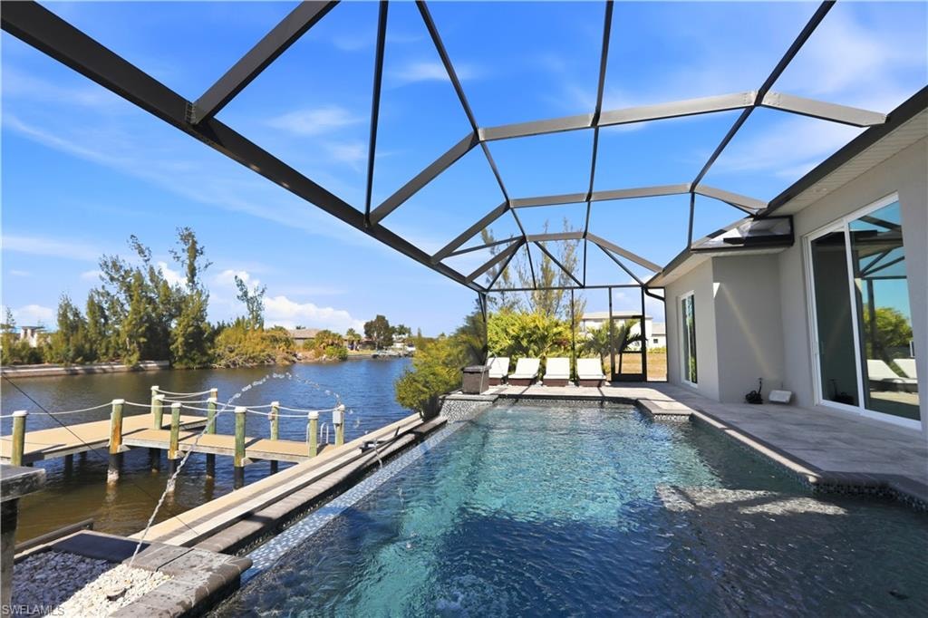 Outdoor pool with water features, lighting features, and sun shelves / tanning ledges.