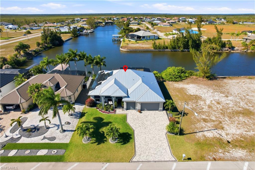 Aerial view of residential area with a 180' wide lot in the rear by the dock.