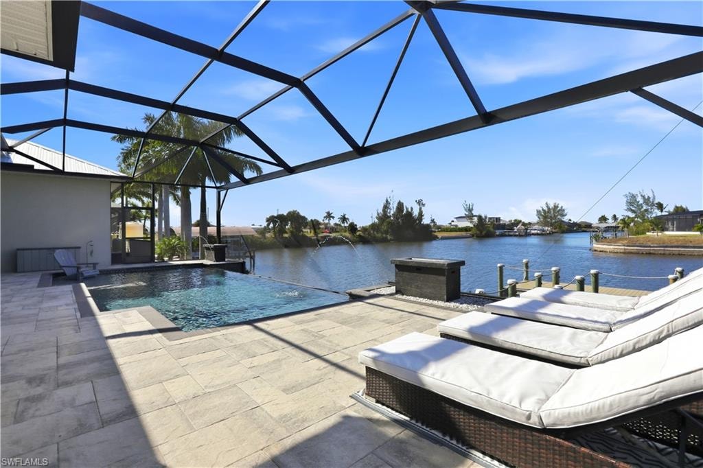 View of swimming pool with an infinity pool, a lanai, and a patio area with panoramic views across the entire back screen.