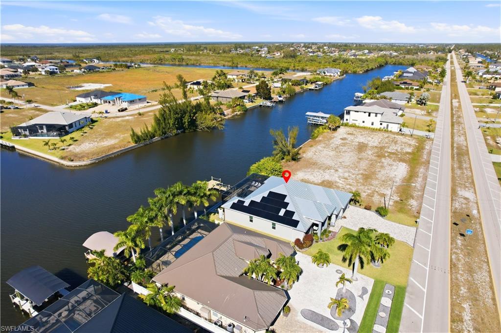 Aerial perspective of suburban area featuring a large body of water