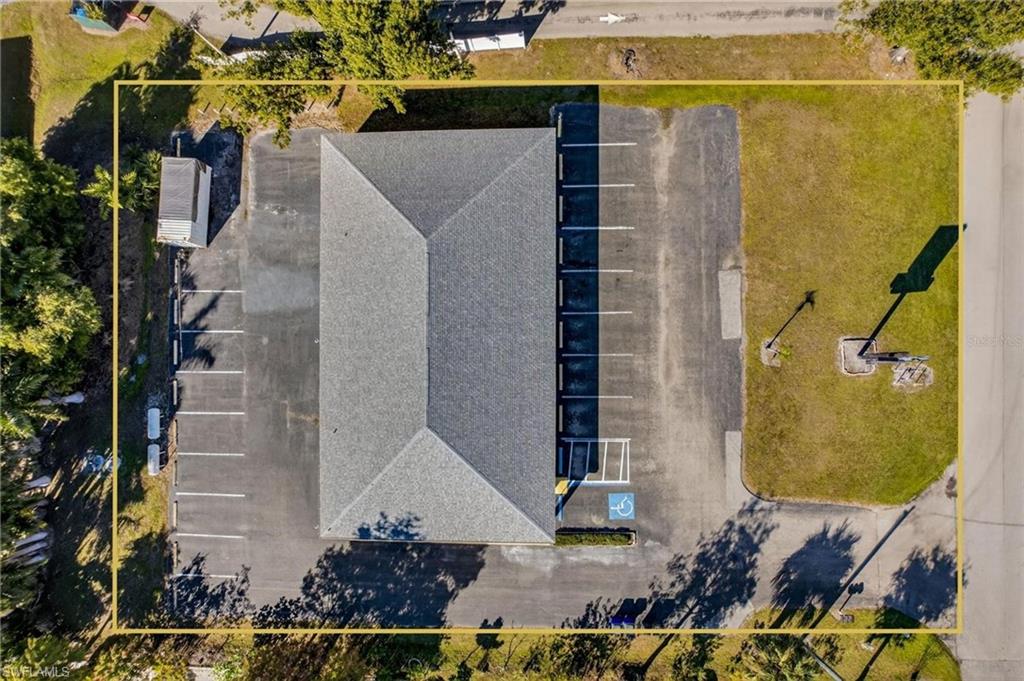 Aerial view of property and surrounding area featuring property parcel outlined