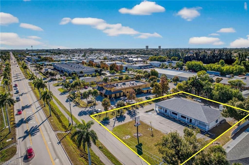 Aerial view of property and surrounding area with property parcel outlined