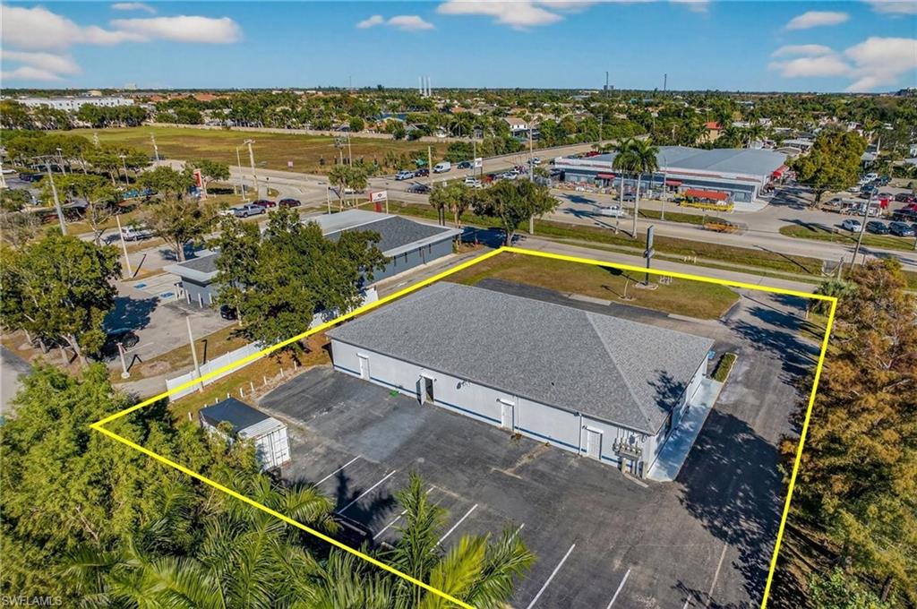 Aerial view of property and surrounding area featuring property parcel outlined