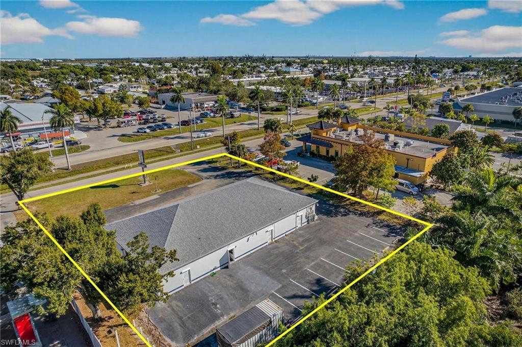 Aerial view of property and surrounding area with property parcel outlined