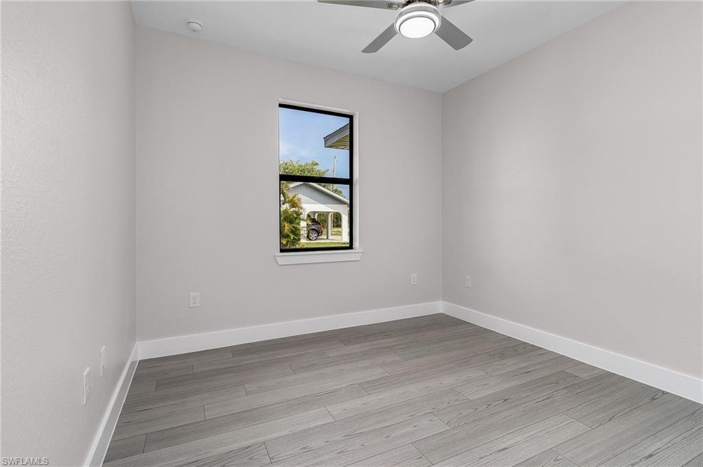 Unfurnished room with light wood-type flooring and ceiling fan