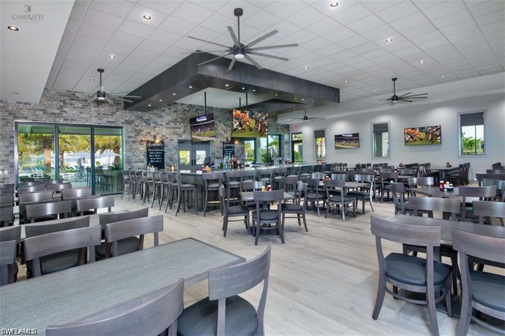 Dining space with plenty of natural light, light wood-style flooring, and a ceiling fan