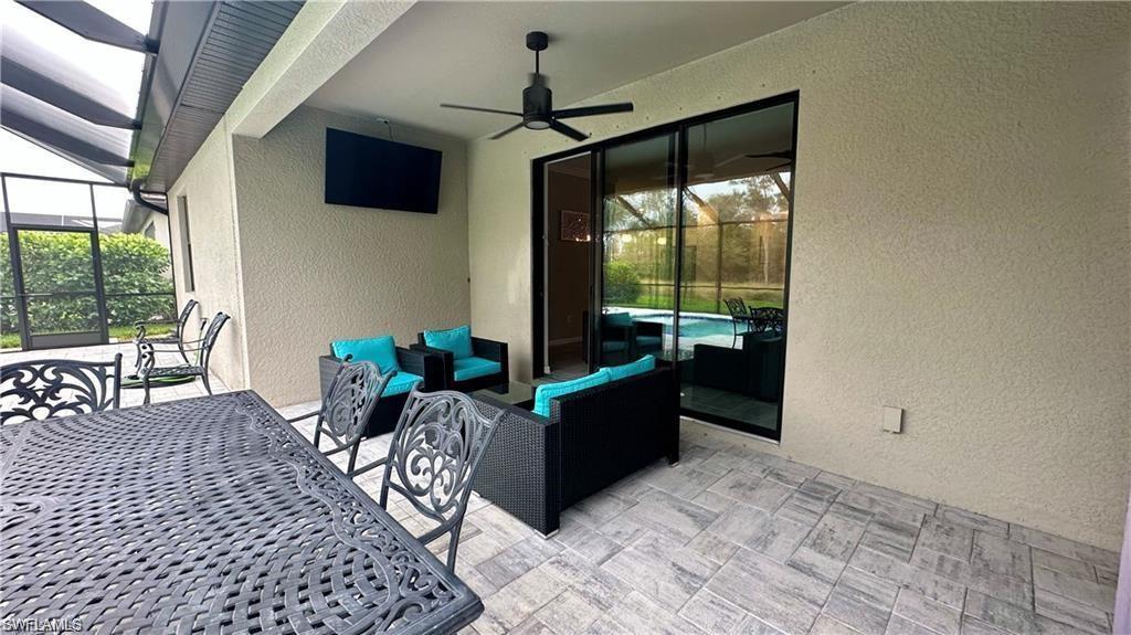 View of patio with ceiling fan, an outdoor hangout area, and a lanai