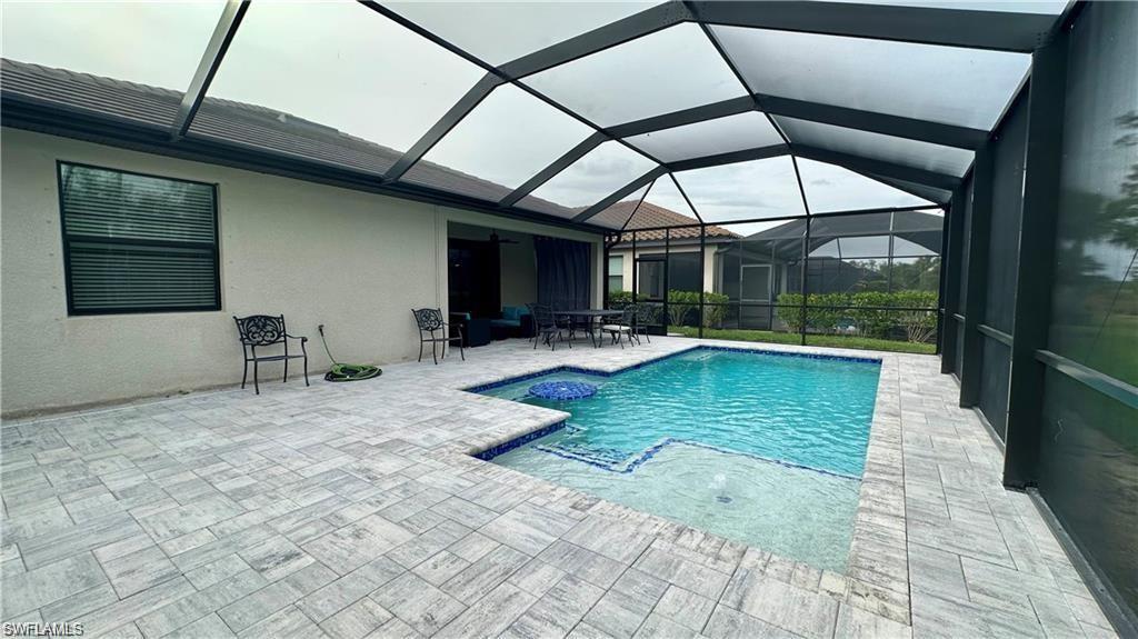 Pool with a lanai and a patio