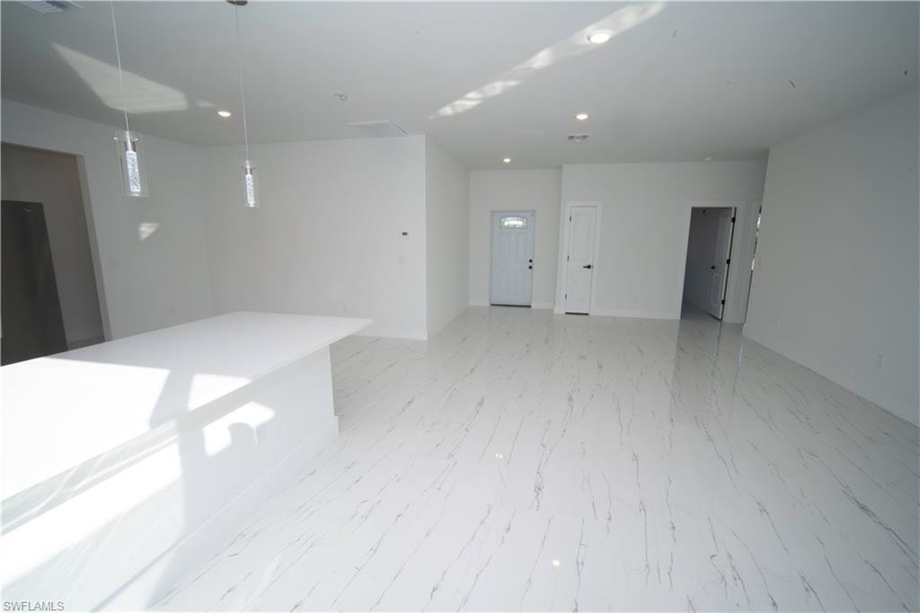 Unfurnished room featuring recessed lighting and baseboards