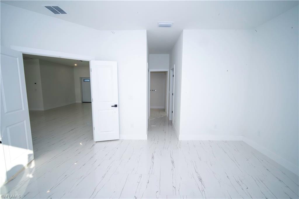 Unfurnished room featuring baseboards
