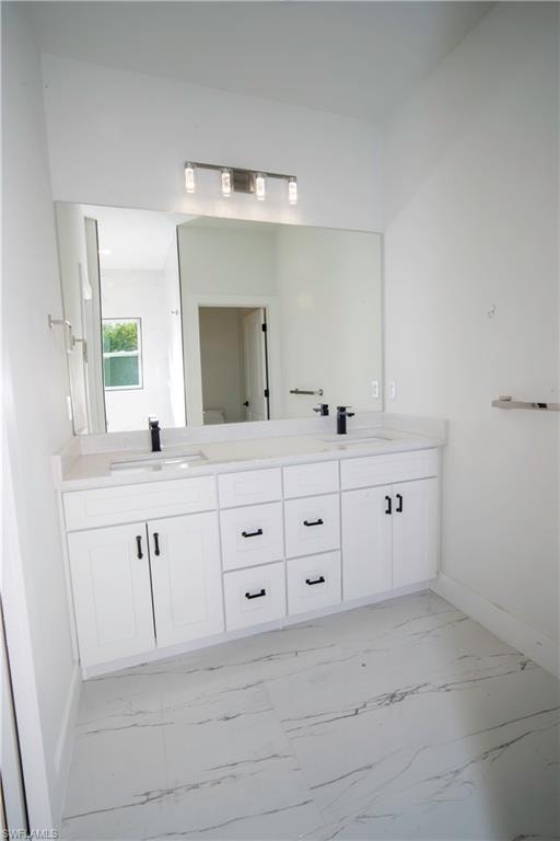 Full bathroom with double vanity and light marble finish floors