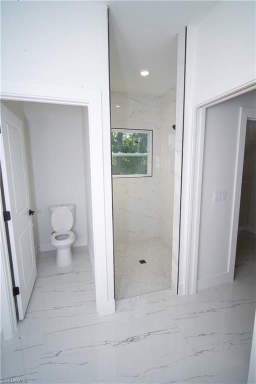 Full bathroom featuring light marble finish floors, a marble finish shower, and recessed lighting