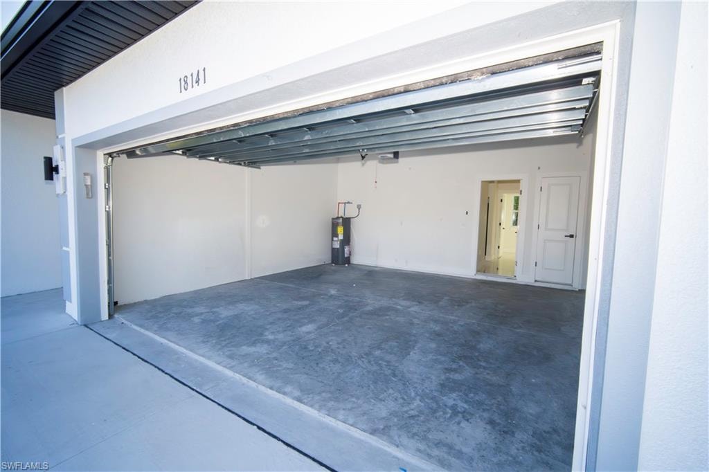 Garage featuring electric water heater