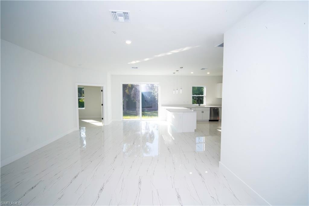 Empty room with recessed lighting and healthy amount of natural light