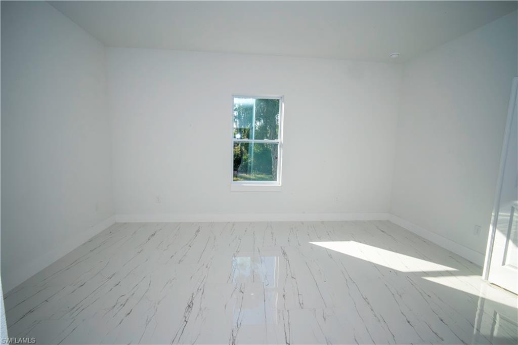 Spare room featuring baseboards