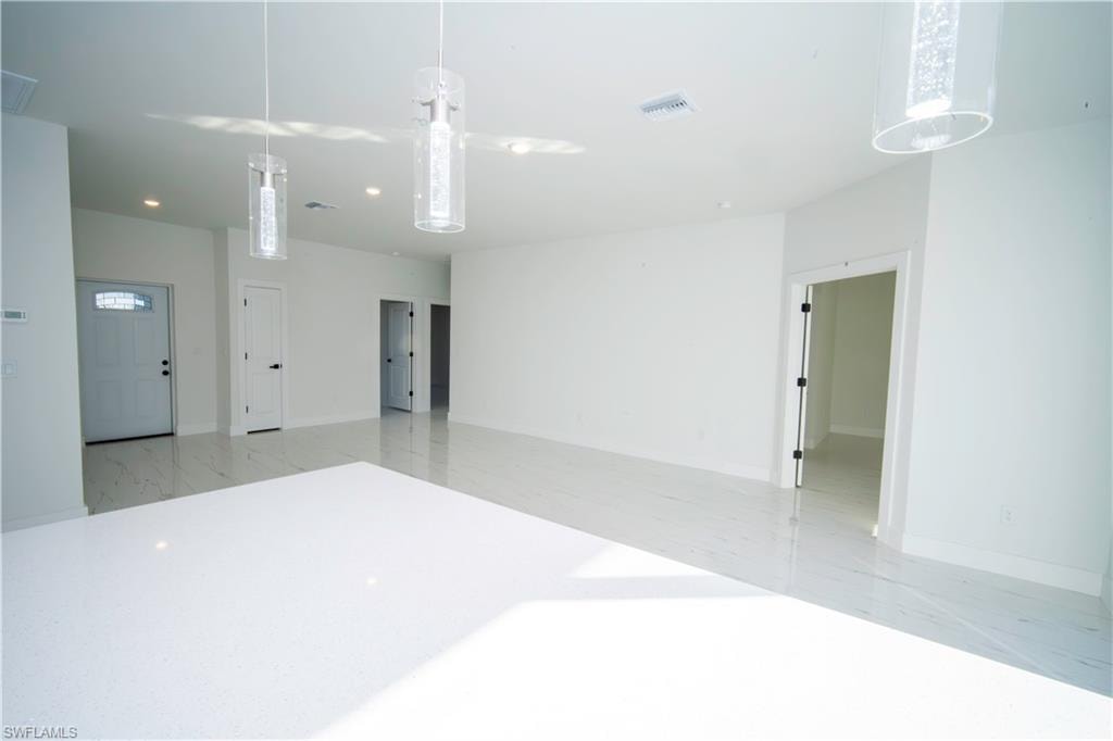 Unfurnished room featuring recessed lighting and light marble finish flooring