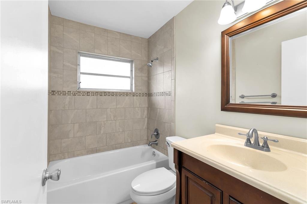 Bathroom featuring vanity and tub / shower combination