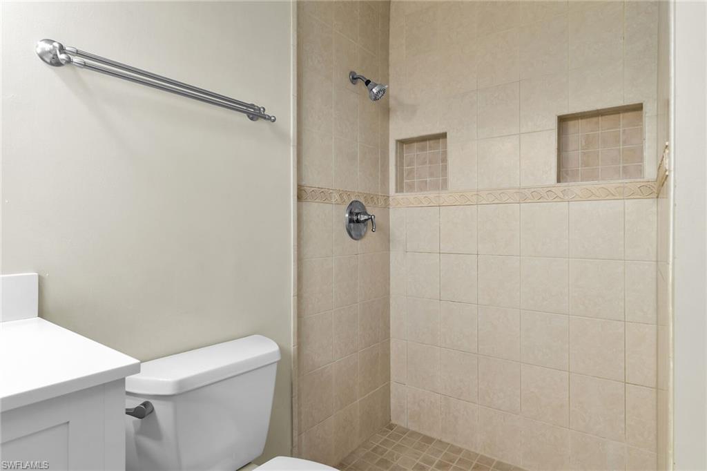 Bathroom with a tile shower and vanity