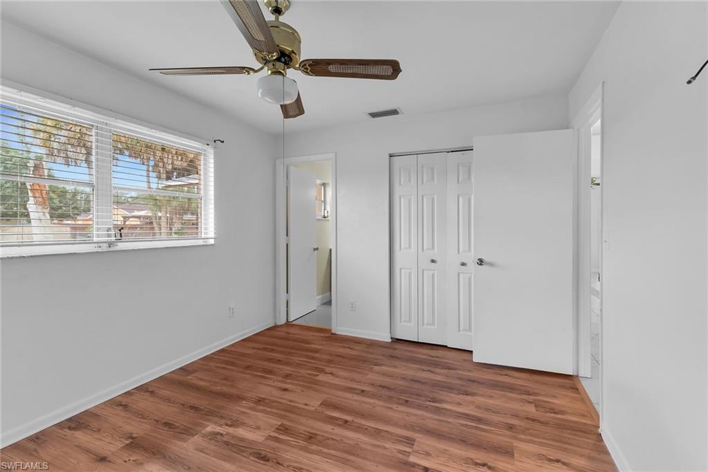 Unfurnished bedroom featuring wood finished floors, ceiling fan, and a closet