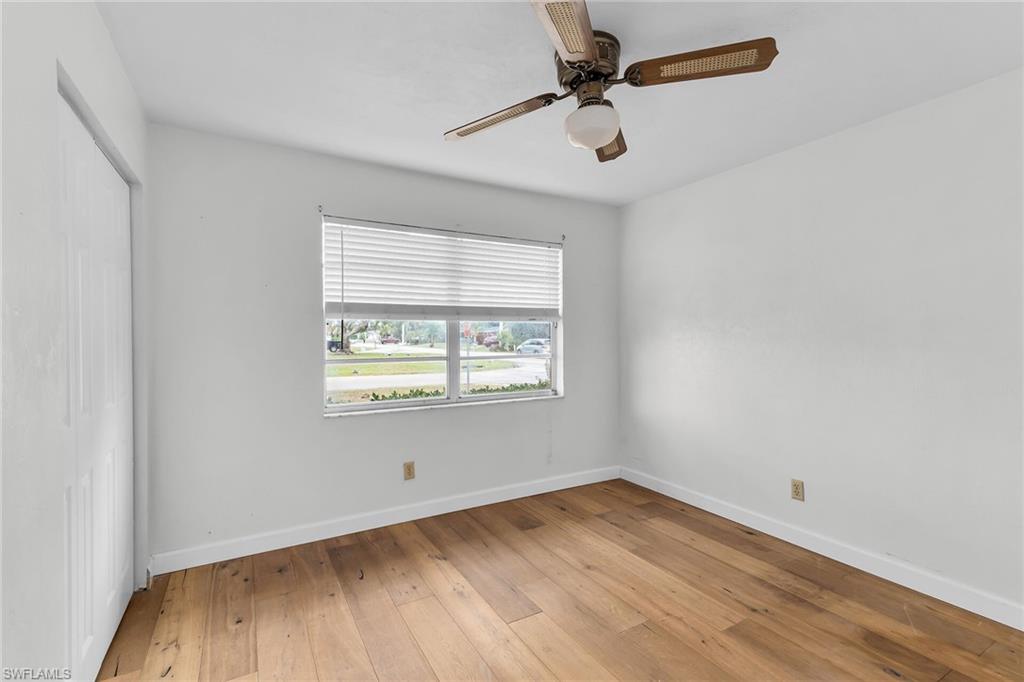 Spare room with light wood finished floors and ceiling fan