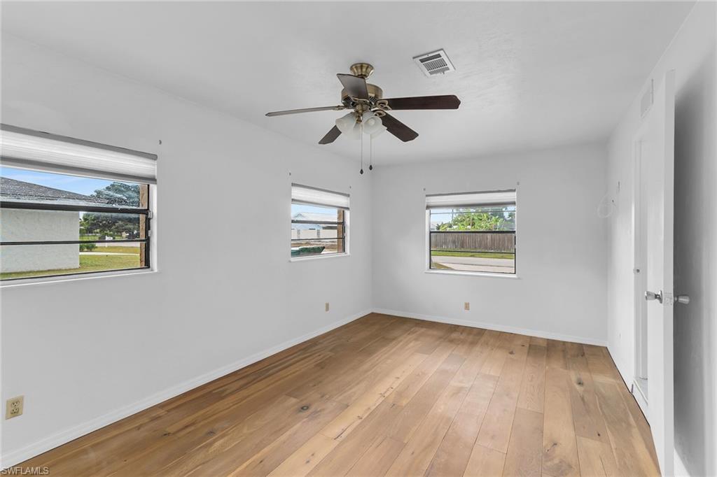 Empty room with light wood-type flooring and ceiling fan